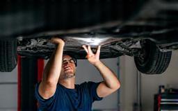 Image representing a mechanic inspecting a car undercarriage